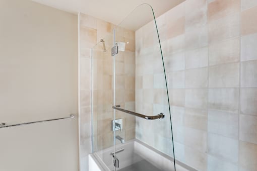 A shower with a glass door and a glass shelf at Skyview Sunset Apartments, Los Angeles, CA, 90046