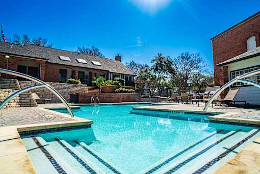 A swimming pool with a sunny sky.