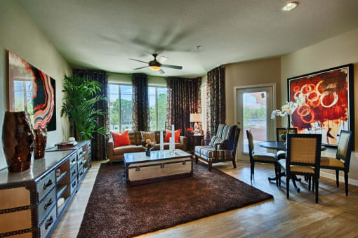 Apartments for Rent in Chandler - Monument - Spacious Living Room with Wood-Style Flooring, Ceiling Fan, and Large Windows
