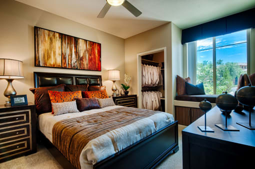 Elevation Apartments in Chandler, AZ with Wall to wall carpet, walk-in closet, white walls, and a large window