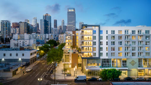 a cityscape with a large white building in the foreground and the san francisco skyline in