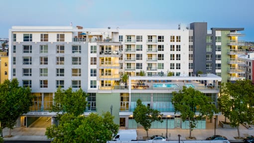 an aerial view of an apartment building with a pool in front of it