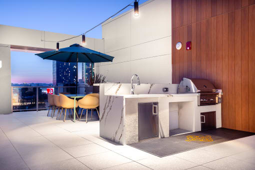 Apartments Near FIDM - The Emerald - Rooftop Sky Terrace with Grilling Station Nearby Seating Area, BBQ Grill, and Quarts Outdoor Kitchen Counterspace