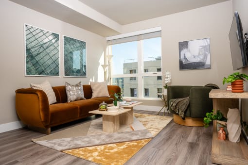 Apartments for Rent in Downtown Los Angeles, CA - The Emerald - Living Room with Floor-to-Ceiling Window, Abstract Coffee Table, and Luxury Plank Flooring