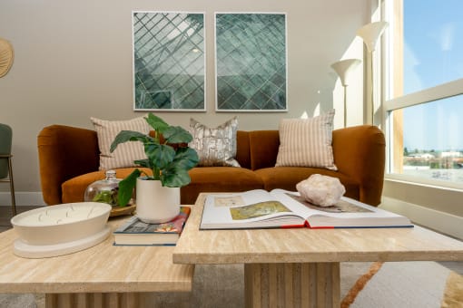 Apartments for Rent in Downtown Los Angeles, CA - The Emerald - Living Room with Floor-to-Ceiling Window, Abstract Coffee Table, and Luxury Plank Flooring