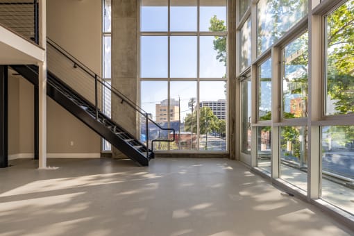 a large open space with large windows and a staircase