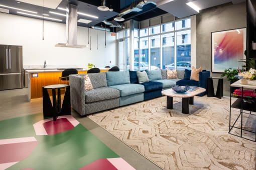 a living room filled with furniture and a large window
