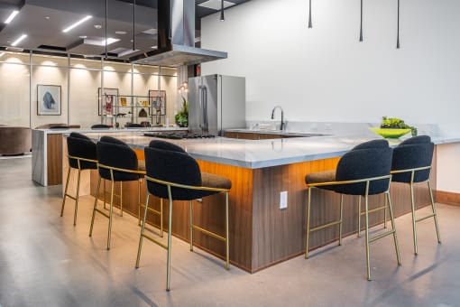 a kitchen with an island and stools