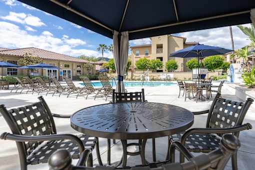 Seating area at pool of FountainGlen Stevenson Ranch