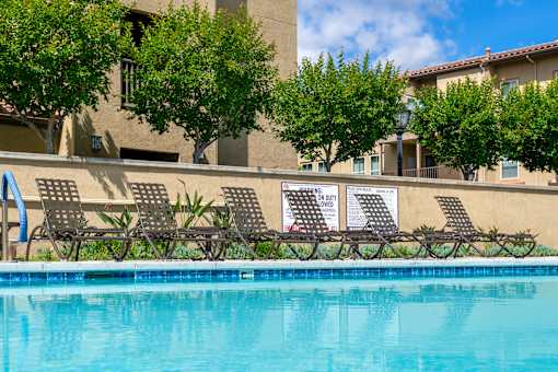 Chaise lounges at pool area FountainGlen Stevenson Ranch
