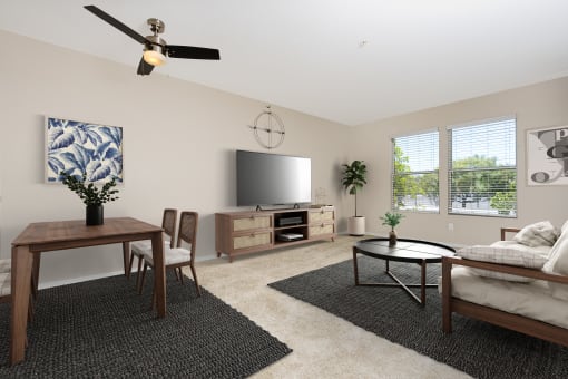 a living room with a ceiling fan and a flat screen tv at 55+ FountainGlen Temecula, California