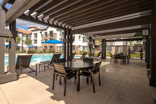 FountainGlen Grand Isle Poolside Patio with Tables and Chairs at 55+ FountainGlen Grand Isle, Murrieta California