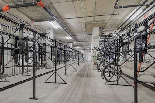 A long hallway with bicycles on stands at Wilshire Valencia Apartment, Los Angeles, California