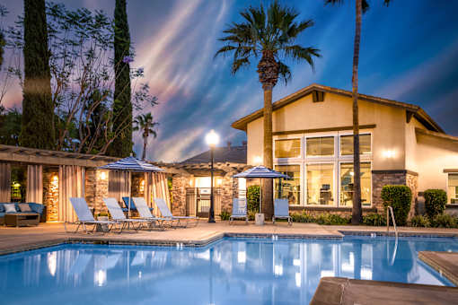 Pool in front of house at The Grove Apartments, California, 91761