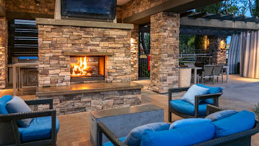 Stone fireplace at The Grove Apartments, California