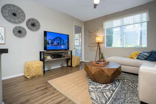 Living room with a television at The Grove Apartments, Ontario, CA