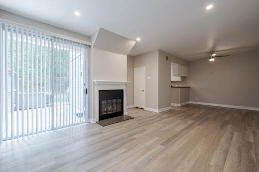 A room with a fireplace and wooden floors.