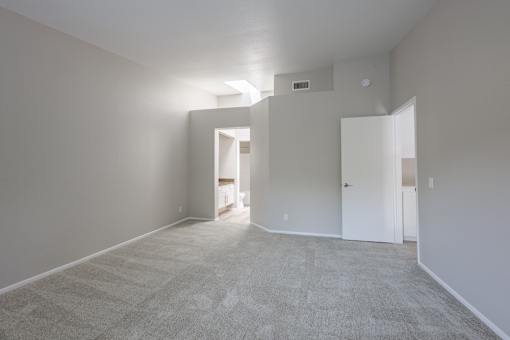 A room with carpeted floor and white walls.