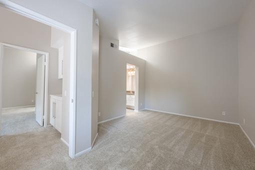 A room with a carpeted floor and white walls.