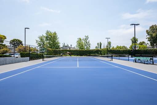 A tennis court with a net and no players.