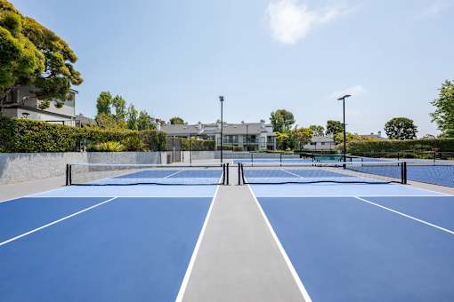 A tennis court with a net and two posts.