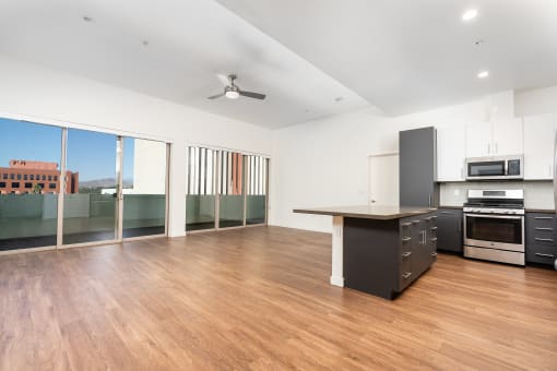 Penthouse with kitchen, wood style flooring and large windows at Imperial Hardware Lofts, Riverside