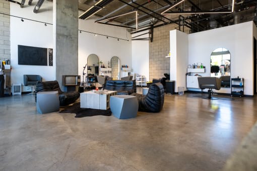 a living room with couches and tables in a warehouse at Imperial Hardware Lofts, California, 92501