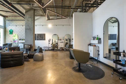 Interior of neighborhood salon with seating area and salon chairs and mirror. at Imperial Hardware Lofts, Riverside, CA, 92501