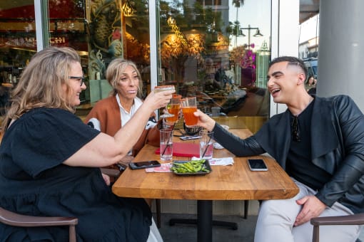 People with drinks outside of a local rest at Imperial Hardware Lofts, California, 92501