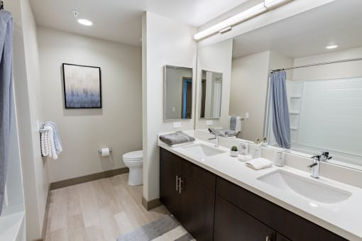 furnished bathroom with dual sinks