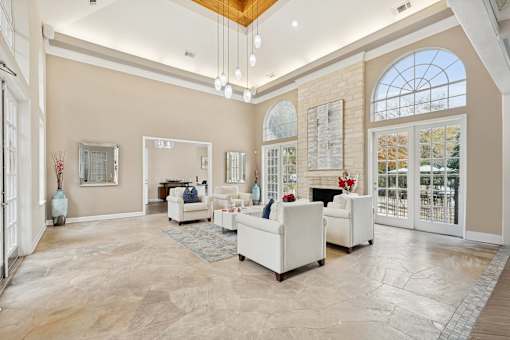 A spacious living room with a fireplace and a large window.