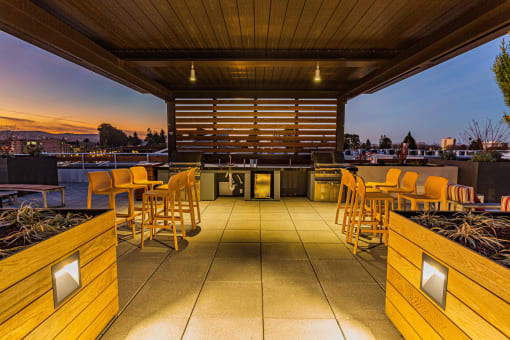 Rooftop Grill Area With Wood-Style Seating, City Views, And Gazebo-Style Covering. at Bayswater Apartments, Burlingame, 94010