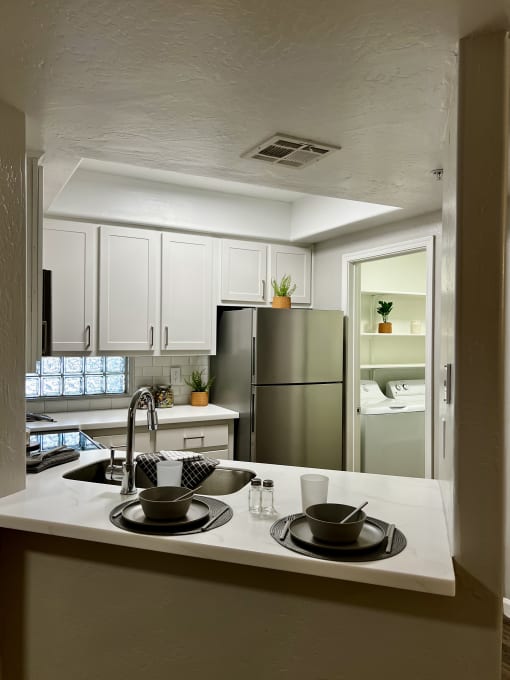 a kitchen with a sink and a refrigerator