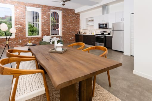 a dining room and kitchen with a wooden table and chairs at Imperial Hardware Lofts, California