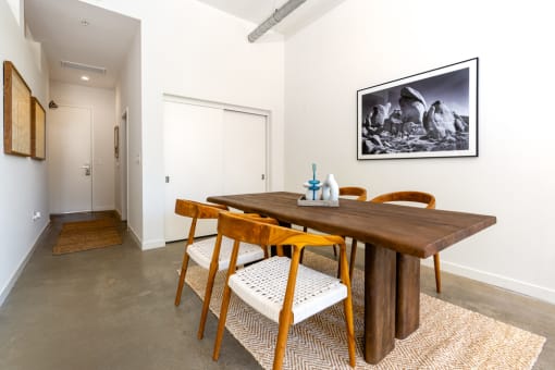 a dining room with a wooden table and chairs at Imperial Hardware Lofts, Riverside, 92501
