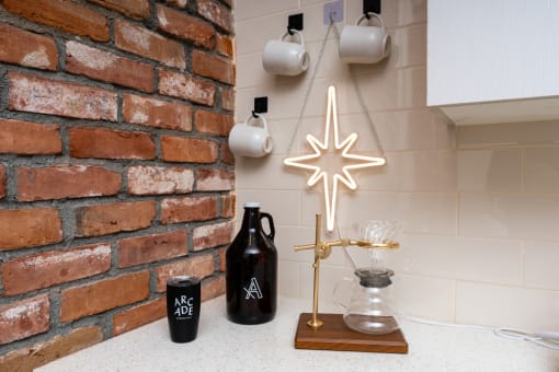 a christmas star hanging on a kitchen wall next to a brick wall at Imperial Hardware Lofts, California, 92501