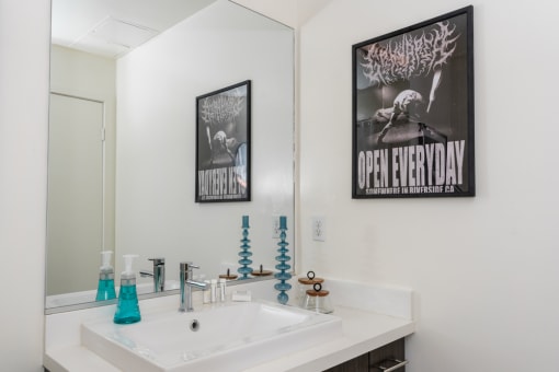 a white bathroom with a sink and a mirror at Imperial Hardware Lofts, Riverside, 92501