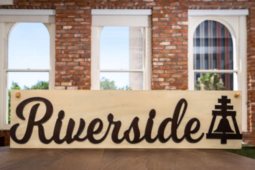 a wooden sign with the word rutherford in front of a building at Imperial Hardware Lofts, Riverside, CA, 92501