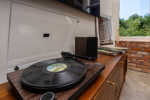 a vinyl record on a record player in a room with a window at Imperial Hardware Lofts, Riverside