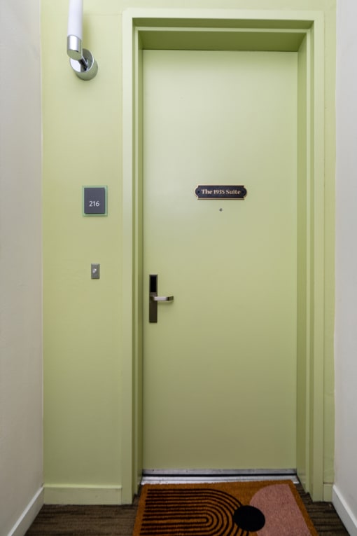 a white door with a sign on the side of it at Imperial Hardware Lofts, Riverside, CA, 92501