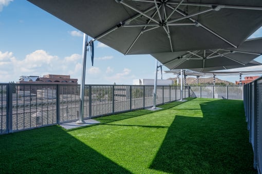 lounge area with grass and umbrellas at Imperial Hardware Lofts, Riverside, CA, 92501
