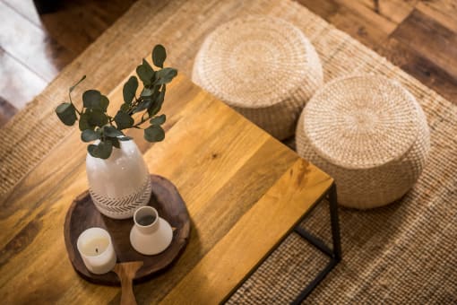 a table with a vase and candles on it