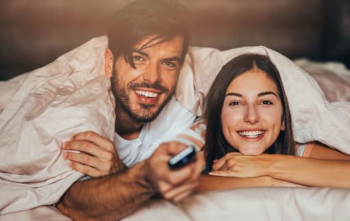 couple in bed watching tv at Monaco at McCormick Ranch, Arizona 85258