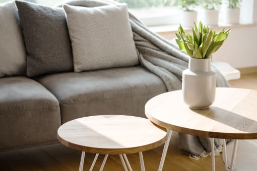 a living room with two coffee tables and a couch in the background