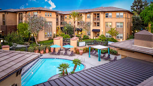 A large apartment complex with a pool and patio area.