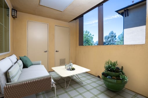 a small patio with a couch and a coffee table