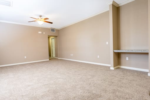 a bedroom with carpet and a ceiling fan
