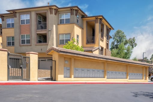 an apartment building with a garage on a sunny day