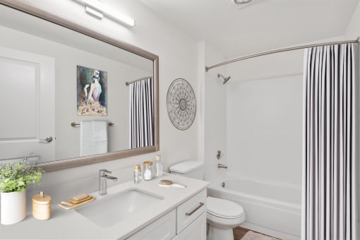 a bathroom with white walls and a white toilet next to a white tub