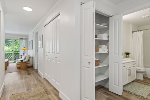 a white bathroom with white closets and a white toilet at Lakemont Orchard, Issaquah, WA 98027  